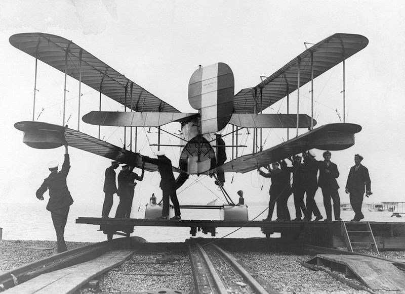 Файл:Men inspect a British airplane with folding wings.jpg