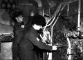 Кочегары в котельном отделении крейсера, ноябрь 1942 г. Проверка температуры и давления.