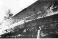 Admiral Hipper в доках на ремонте. Из пробоины выливается вода из затопленных отсеков.